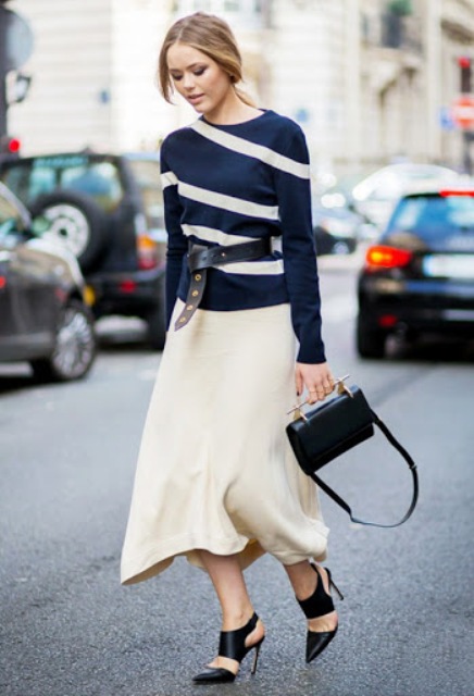 With beige midi skirt, black leather bag and black cutout high heels