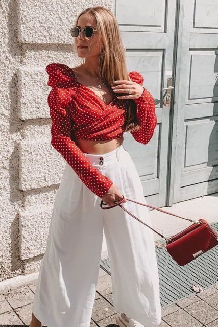 With white culottes, sneakers and red bag