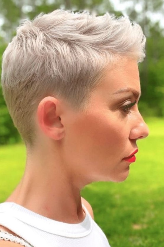 a blonde short pixie haircut with side parting and a bit of styling is an easy to maintain hairstyle that wows