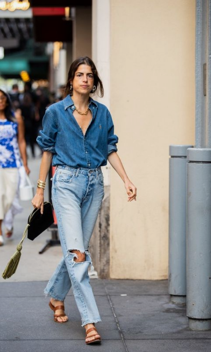 a bold blue chambray shirt, light blue ripped jeans, brown sandals and a statement necklace