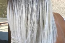 a darker root and silver blonde balayage for a chic and bold look with a trendy feel