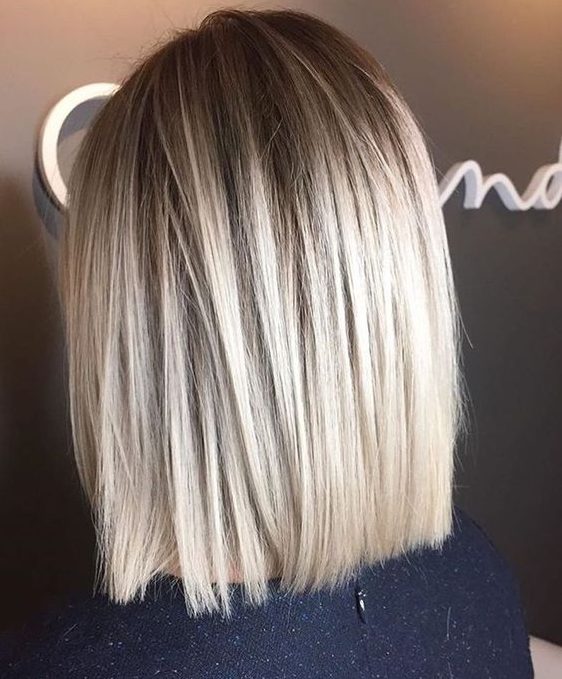 a long straight bob with a darker root and a lot of volume is a stylish and chic idea for a modern and fresh look