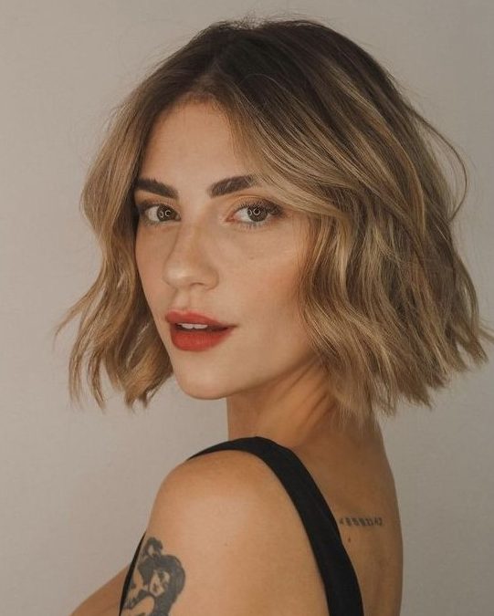 A relaxed bronde warm shaded midi bob with waves and a darker root is a catchy and cool idea