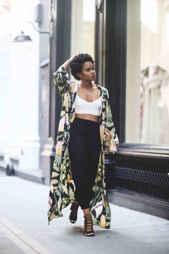 a stylish look with a white crop top, black cargo pants, black laser cut heels and a bold tropical duster