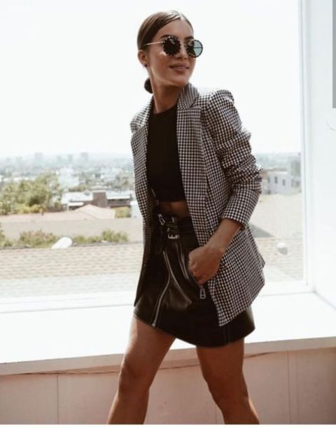 a trendy outfit with a black crop top, a black leather mini, an oversized plaid blazer and stylish sunglasses