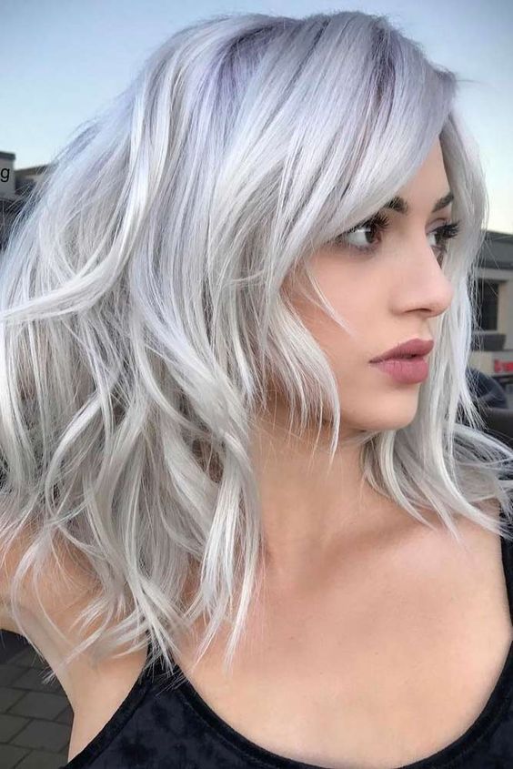 Gorgeous medium length hair with layers and messy waves, done in silver blonde, is a very stylish and eye catching idea