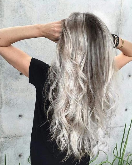 long brunette hair with silver blonde balayage, volume and waves is amazing for a bold modern look