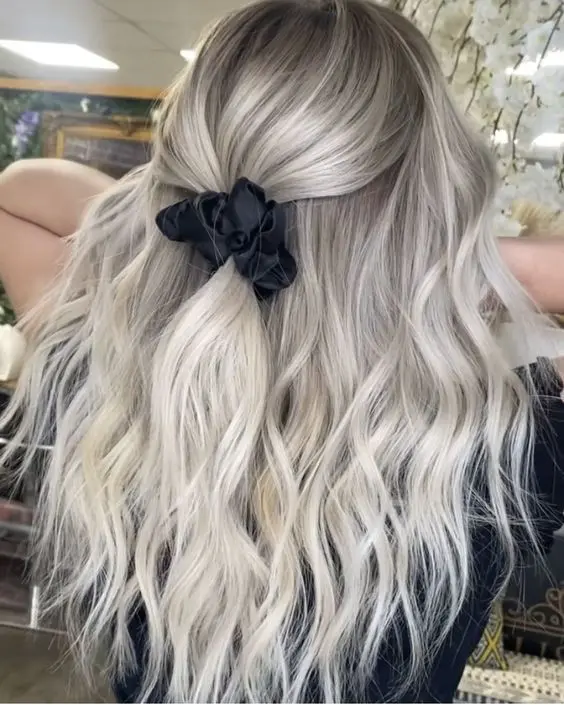 long silver blonde hair styled as a half updo, with waves down looks beautiful and very girlish