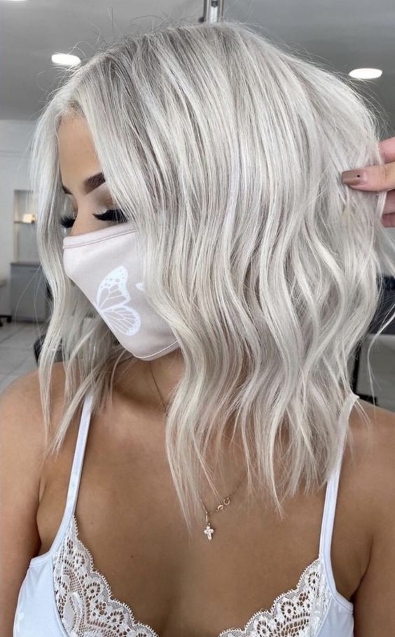 long silver blonde hair with volume and waves is a chic and beautiful idea to rock, it looks nice and bold