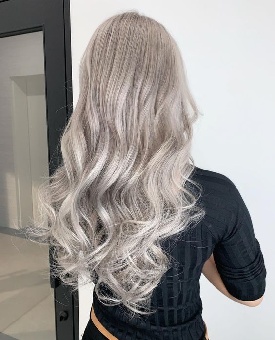 Long silver blonde hair with waves and a lot of volume is a chic and stylish idea, it looks very eye catching and lovely