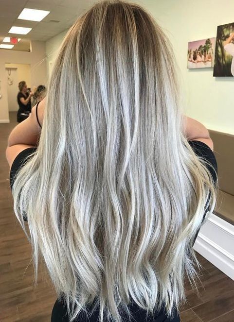 long toned silver champagne hair with icy blonde highlights and darker roots is chic