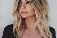 lovely rooty gold blonde hair with slight waves is a very stylish and trendy idea to wear in summer