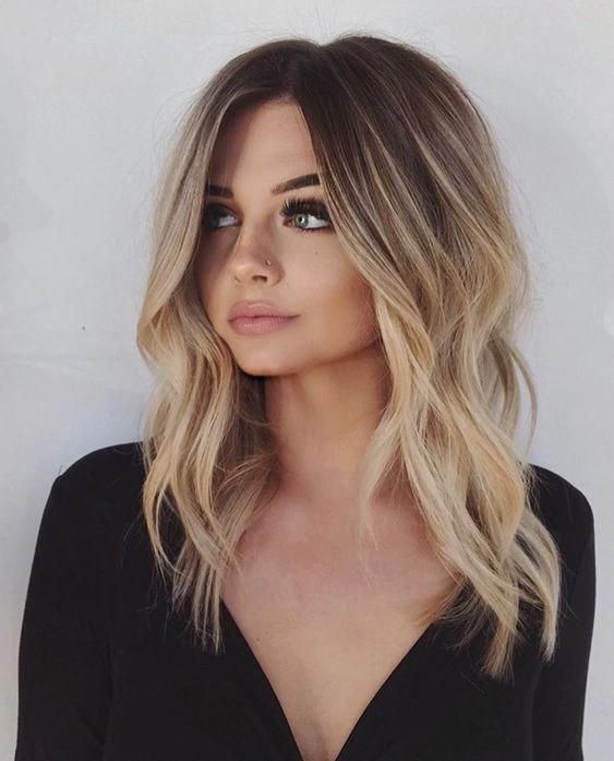 lovely rooty warm blonde hair with slight waves is a very stylish and trendy idea to wear in summer
