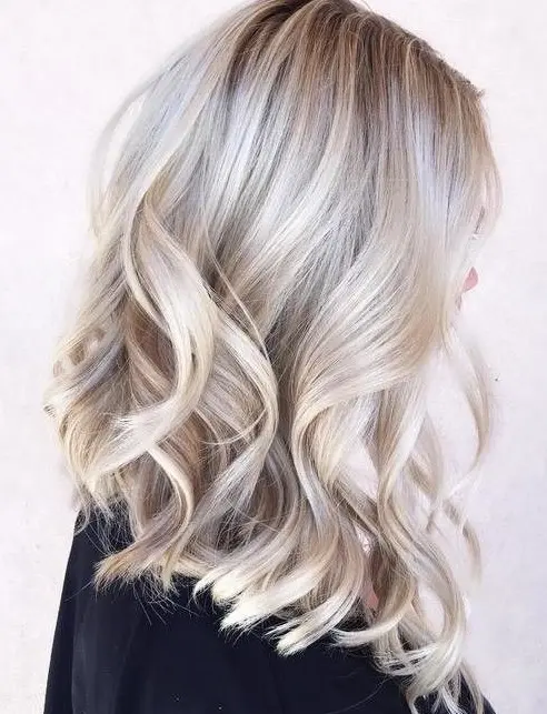 medium-length blonde hair with silver blonde balayage, volume and waves is a very chic and lovely idea