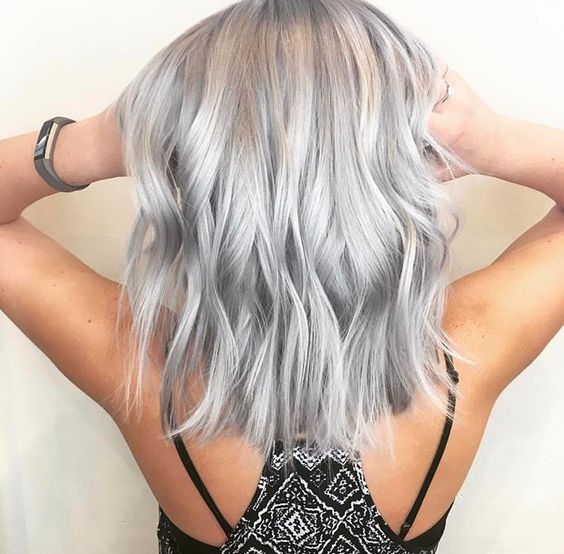 Medium length silver blonde hair with volume and waves is a stylish idea, the length is the most actual and the color is edgy