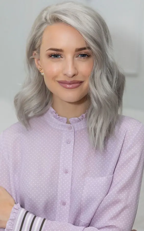 Medium length silver blonde wavy hair with a lot of volume is a stylish and catchy idea to try
