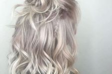 shoulder-length hair of a beautiful silver blonde shade, with waves and styled as a half updo is a chic and cool idea
