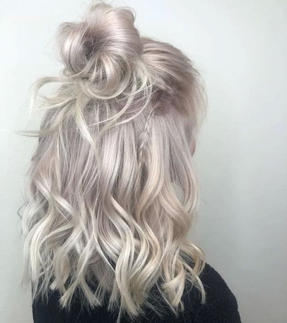Shoulder length hair of a beautiful silver blonde shade, with waves and styled as a half updo is a chic and cool idea