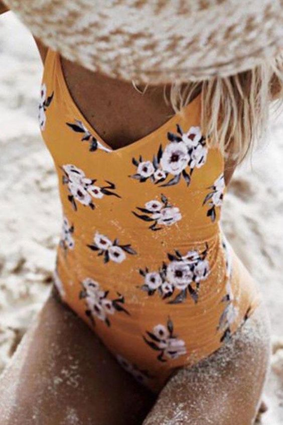 a yellow floral one piece swimsuit with an open back is all that you need to look trendy
