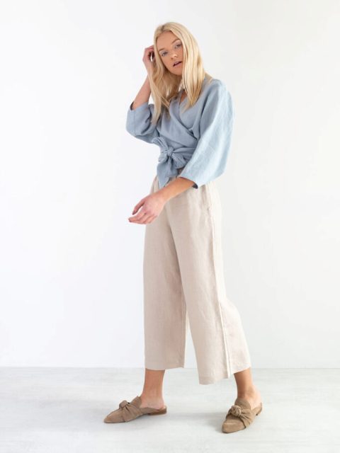 With beige culottes and velvet flat mules
