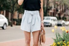 With black ruffled blouse, beige bag and platform sandals