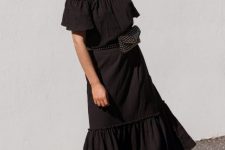 With black wide brim hat, embellished waist bag and lace up flat sandals