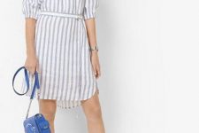 With blue chain strap bag and white and blue sneakers