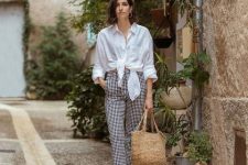 With checked trousers, straw tote bag and brown sandals