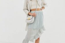 With gray jacket, crop top, crossbody bag and sneakers