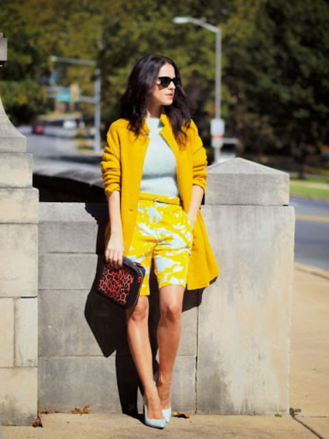 With light blue shirt, yellow coat, leopard printed clutch and light blue pumps