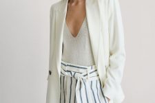 With light gray V-neck top and white long blazer