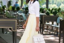 With white button down shirt, white tote bag and white pumps