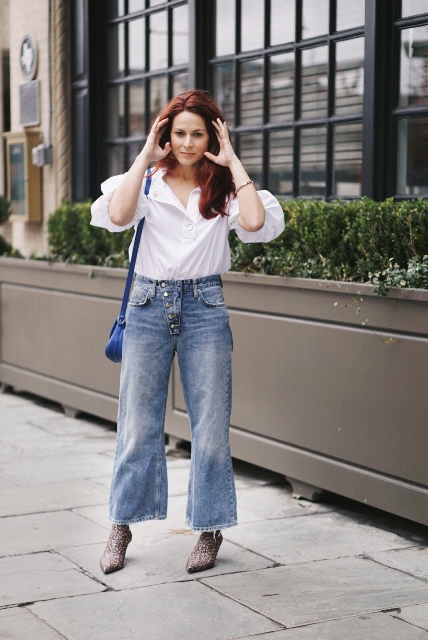 With white shirt, loose jeans and blue bag