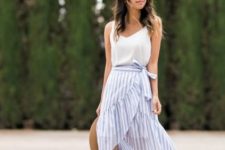 With white sleeveless top, hat and brown platform sandals
