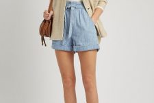 With white top, beige jacket, brown leather bag and mid calf heeled boots