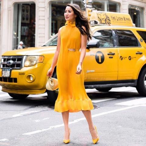 With yellow bag and yellow pumps