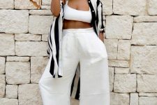 a chic look with a white crop top, wideleg pants, embellished sandals and a black and white striped shirtdress
