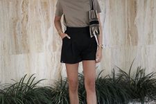 a comfy minimal look with a taupe tee, black mini shorts, white sneakers and a color block bag