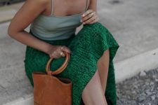 a light green spaghetti strap top, an emerald midi skirt, pink mules and a brown bucket bag