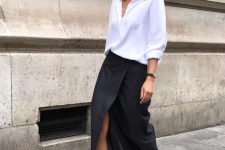 a minimalist outfit with an oversized white shirt, a black wrap maxi, black kitten heels and sunglasses