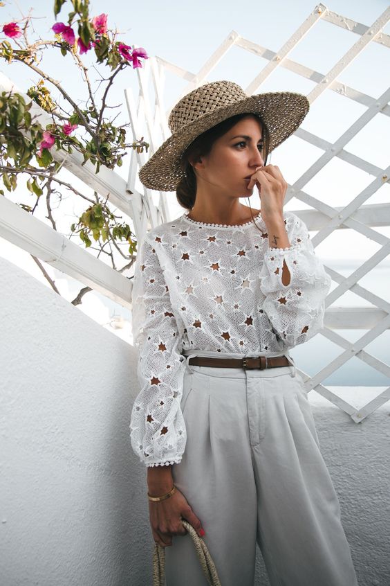 a star cutout blouse, white trousers, a straw hat and a straw bag