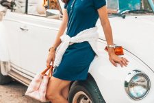 a teal polo mini dress, a white jumper, yellow slippers and a plaid mini bag for a retro-inspired look