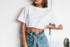 a white cropped t-shirt, blue high waisted shorts and trendy sunglasses for a bold look