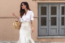 a white shirt with cuffed sleeves, an ivory polka dot ruffle skirt, white shoes and a basket