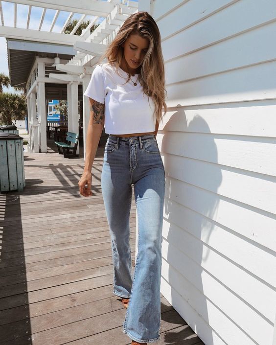 blue high waisted flare jeans, a white cropped t-shirt and layered necklaces for summer