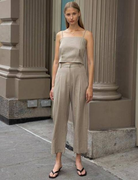 a grey linen suit of a spaghetti strap top and trousers, black heeled flipflops is ideal for work in summer