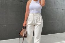 15 a cool hot day look with a white halter neckline top, creamy linen pants, brown slippers, a hat, layered necklaces and a chic bag