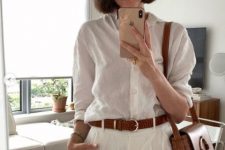 23 a white linen shirt, white linen shorts, a brown belt and a brown bag with a large ring on it