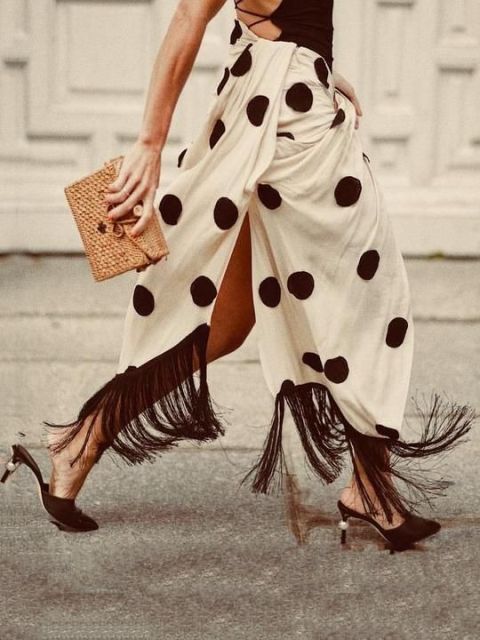With black lace up top, straw clutch and black heeled mules