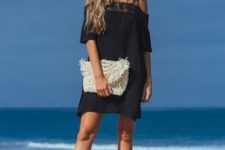 With black off the shoulder mini dress and black sandals